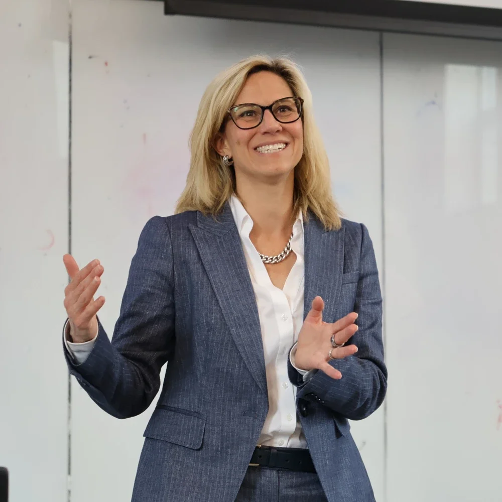 Stephanie Potisek Lee standing at the front of a classroom talking