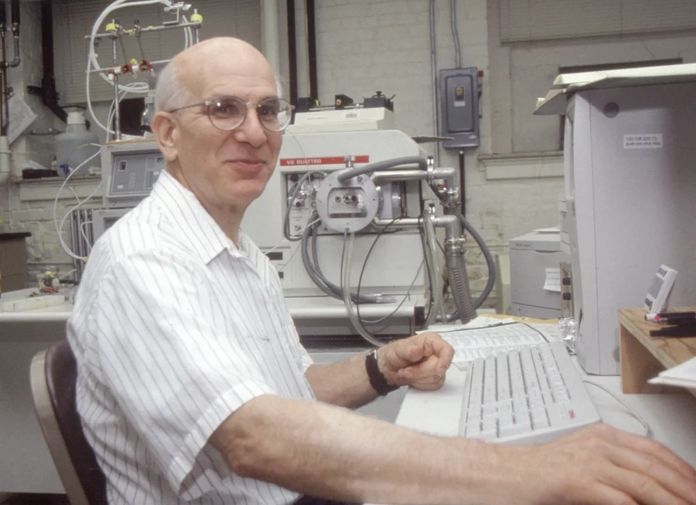 Richard Millberg sitting at a computer keyboard in a lab