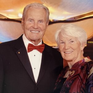 A portrait of Jiri and Ana Jonas standing side by side in formal attire. 