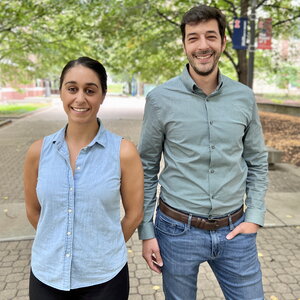 Portrait of Anastasia Manesis and Majed Fataftah standing next to each other on a brick walkway lined with trees on the UIUC campus.