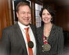 Two people standing side by side with medals around their necks