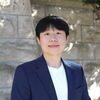 Head shot of Jusung An in front of a brick wall