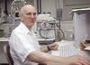 Richard Millberg sitting at a computer keyboard in a lab