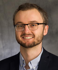 Head shot of Nick Jackson on a dark grey background