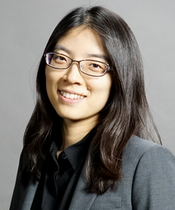 Head shot of Hee-Sun Han in a gray suit and black shirt