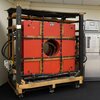 One of the Big Reds, original MRI machine, a very large cube shaped red machine sits in a room on a display at the Beckman Institute.