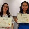 Joenisse Rosado-Rosa and Catherine Jalomo stand next to each other holding their Outstanding Mentoring certificates.