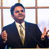 Prashant Jain speaking in front of a large window in the Illini Union