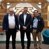 Photo of three researchers standing side by side in atrium at Beckman Institute.