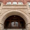Photo focusing on the stone arch at the main entrance to Noyes Laboratory on the west side of the building overlooking the main quad on campus.