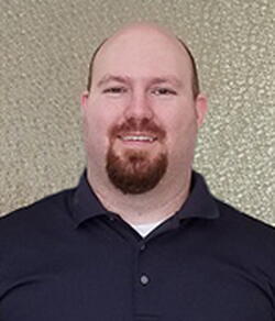 Head shot of Sean Drummond on a tan background