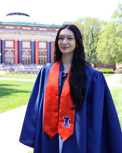 Mary Choy in graduation regalia on Main Quad 